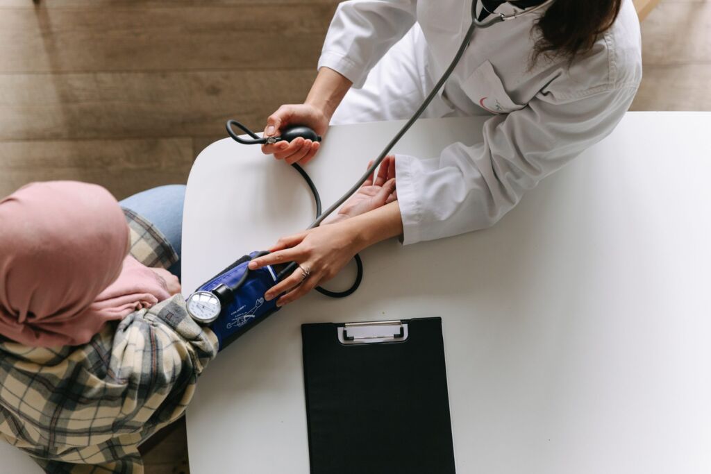 Clinician carrying out a medical check-up for a patient