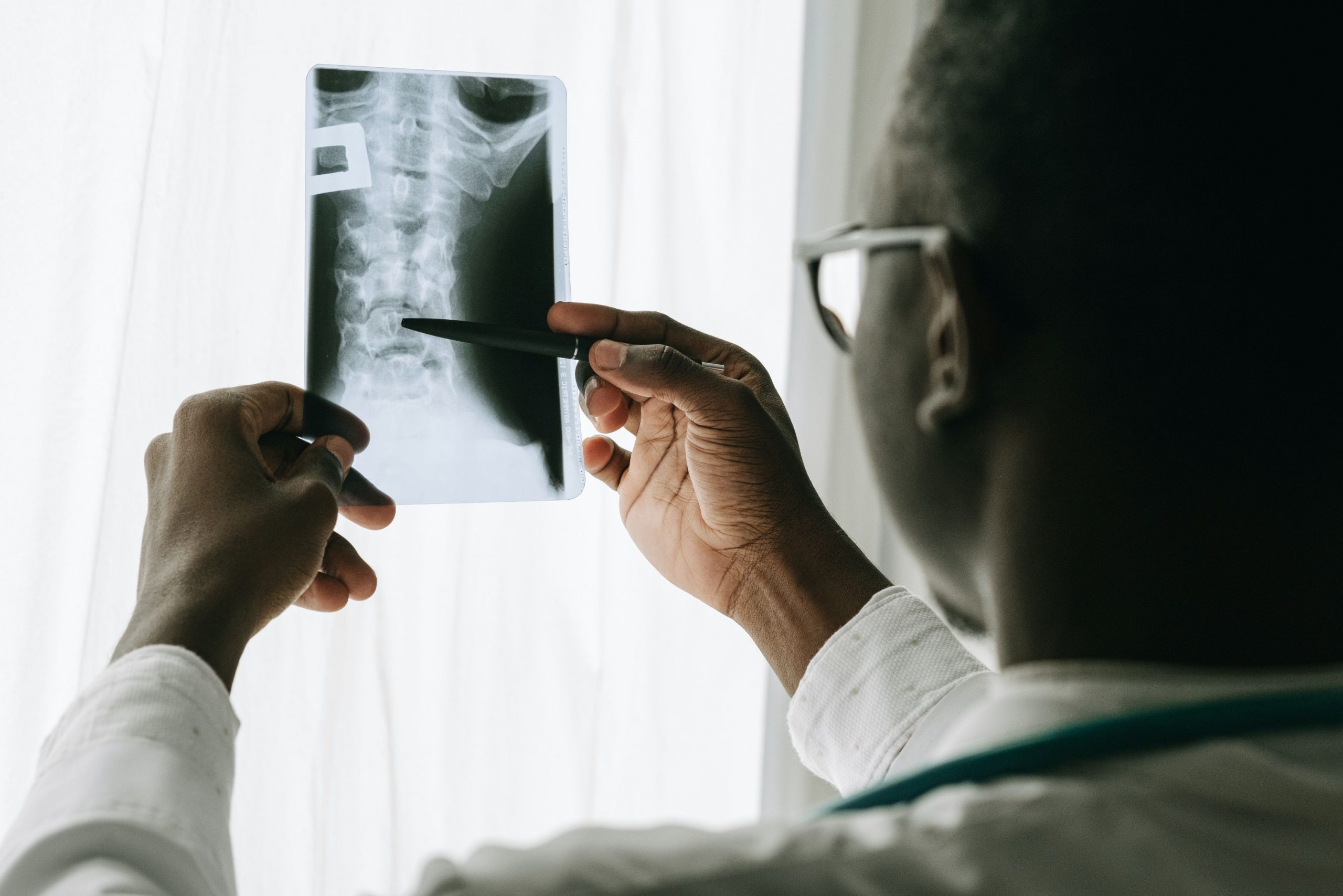Clinician reviewing diagnostic imaging in a medical setting